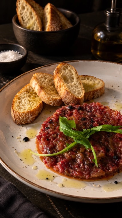 Aged beef tenderloin steak tartare with toast and rocket